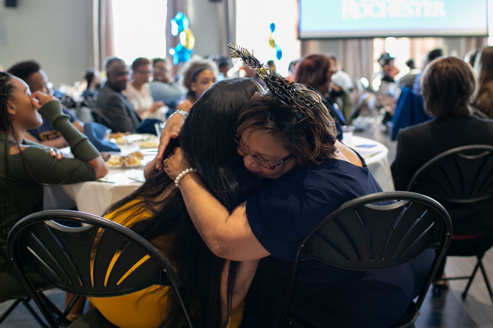 A mother hugs her daughter