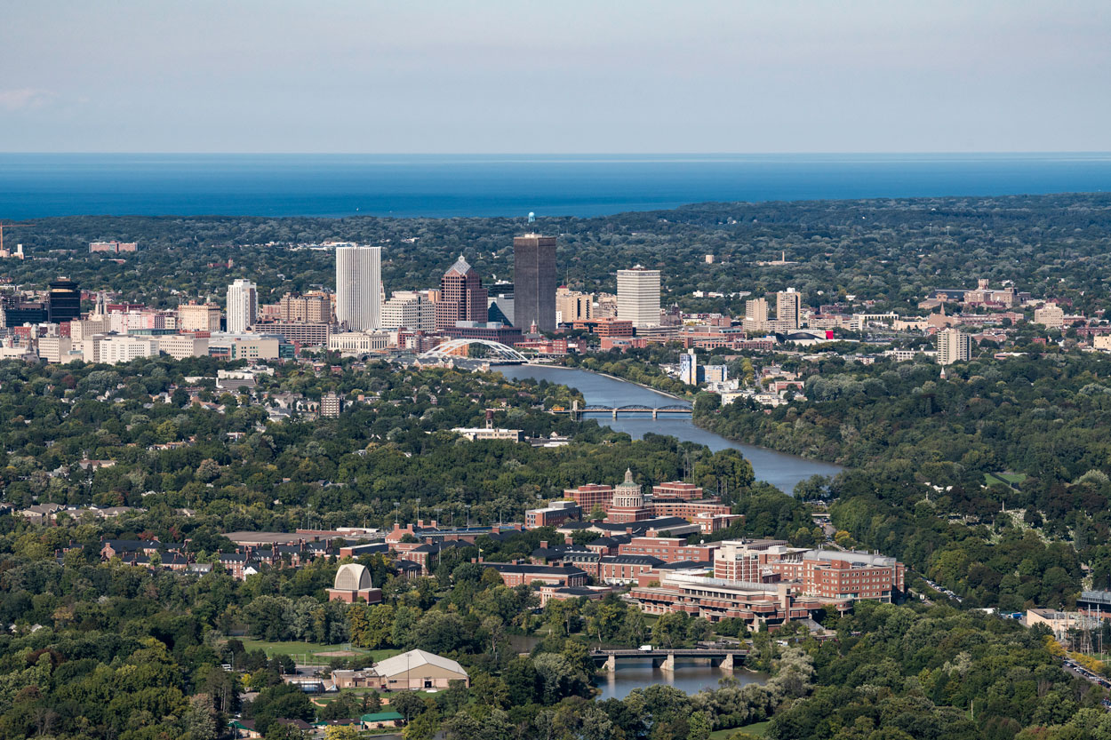 Aerial view of Rochester, NY, showcasing the city skyline with buildings and urban landscape.
