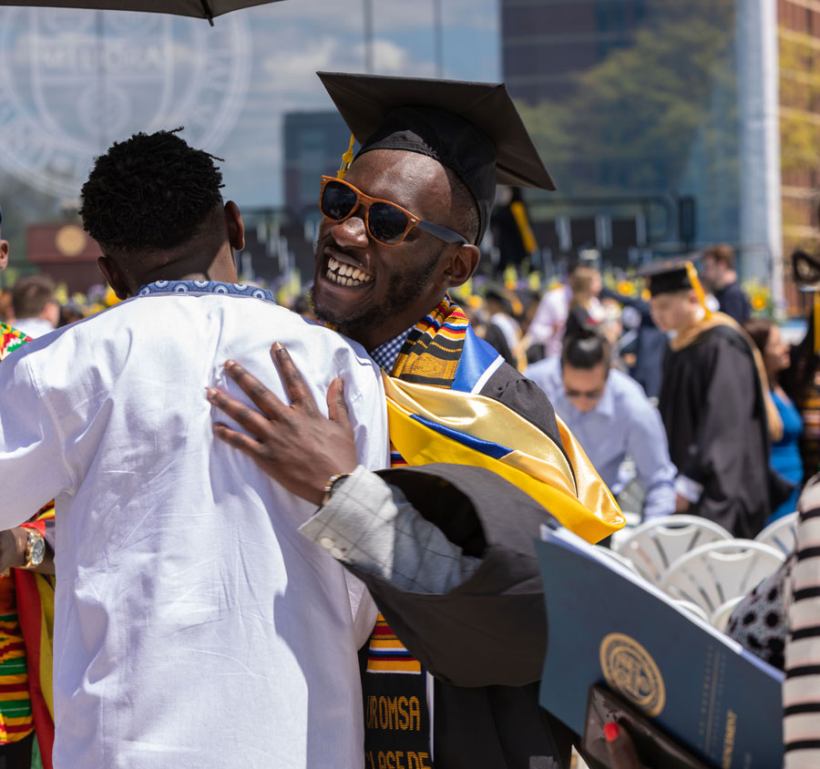 Students celebrating academic success at the UNiversity of Rochester Commencement Ceremony.