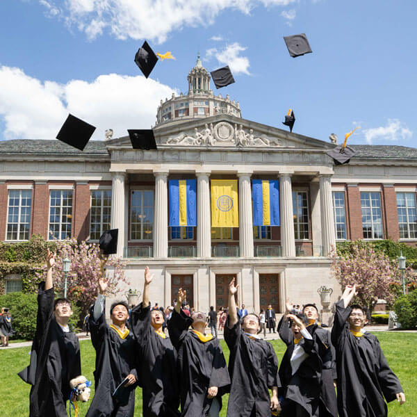 Students toss ther graduation caps in the air after the University of Rochester Commencement Weekend.