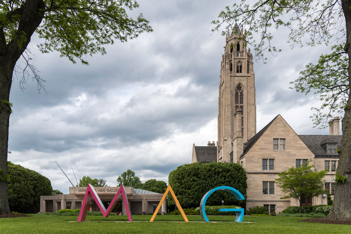 A large sculpture of the word M A G stands in front of the University of Rochester's Memorial Art Gallery building.