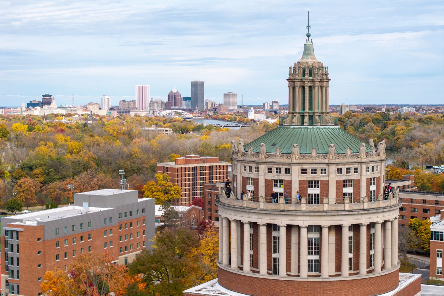 Aerial view of the University of Rochester, showcasing the cityscape and surrounding landscape from above.
