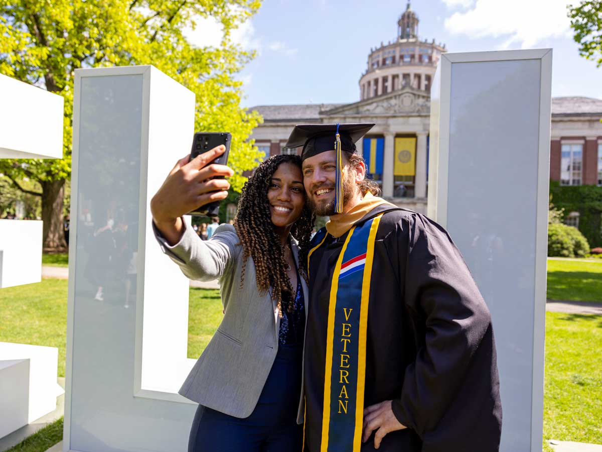 David Caraccio and Jataya Oyphanith take a selfie following University of Rochester's Commencement ceremony — marking the conferral of academic degrees for all undergraduate and graduate students.