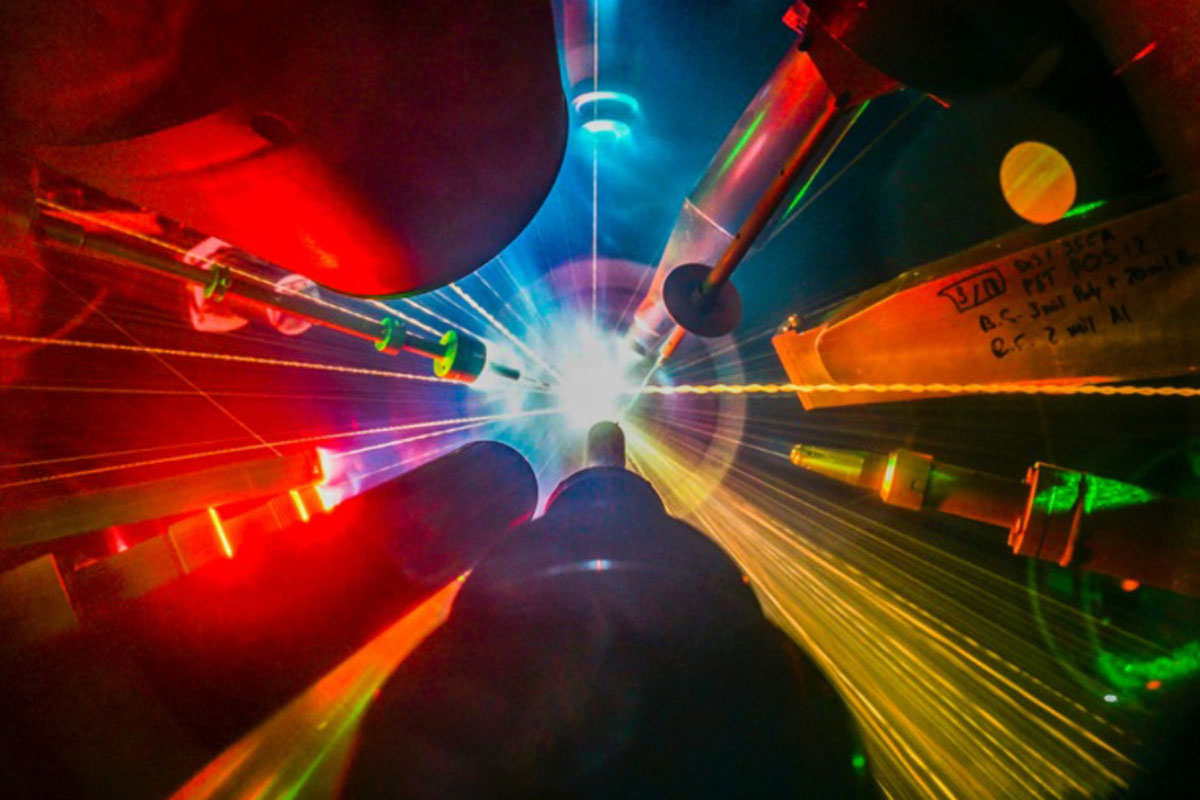 Multiple lasers pointing and shooting at a target during a direct-drive inertial fusion experiment.
