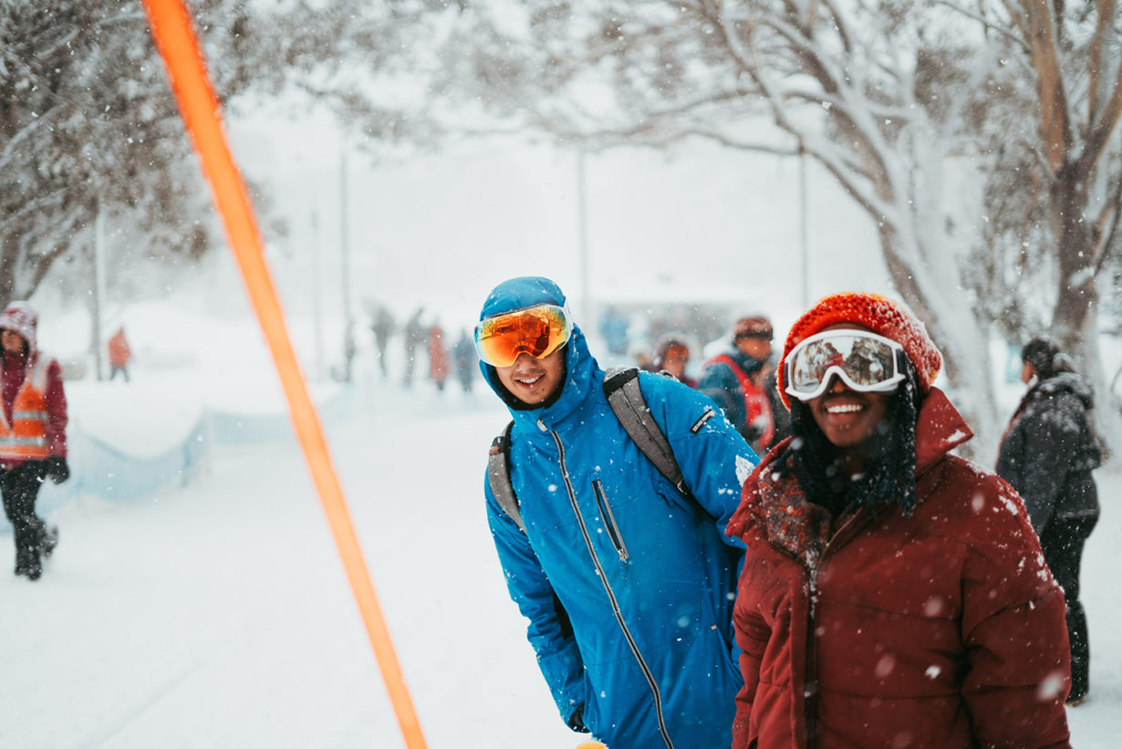 couple wearing ski goggles in the snow
