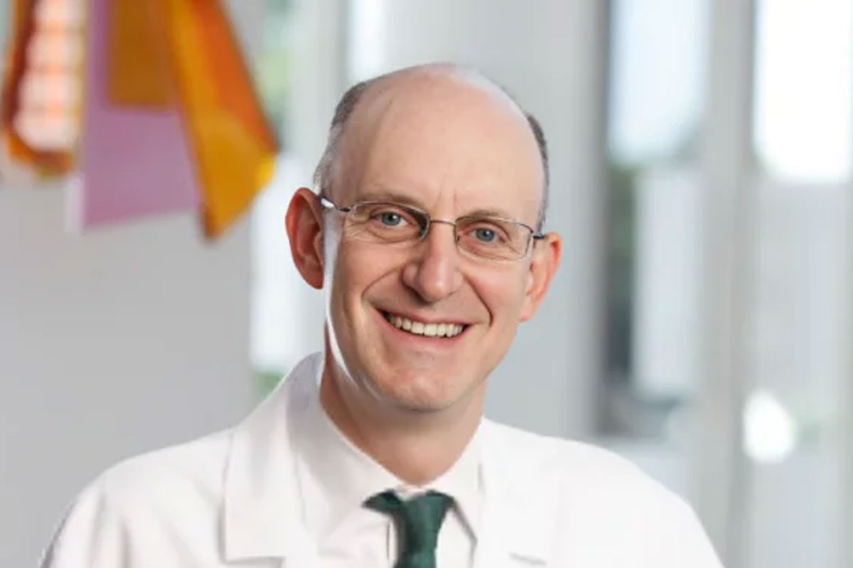 Jonathan Friedberg, MD, MMSc, smiling in a white coat and tie at the University of Rochester Medical Center.