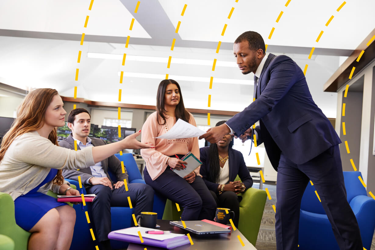 A group of business professionals collaborating and handing each other papers
