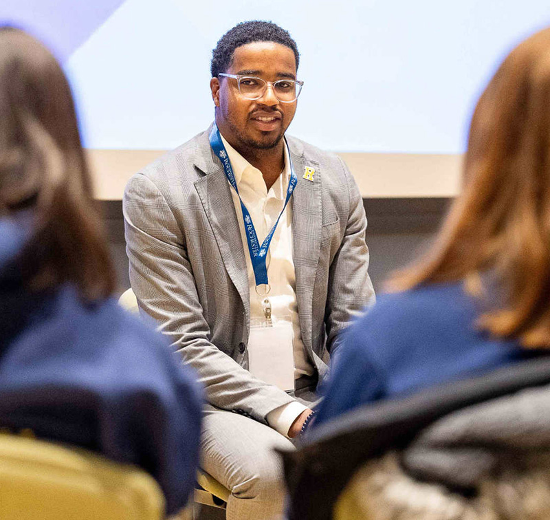 Jamal Holtz ’20 with 2 peoples backs in the foreground