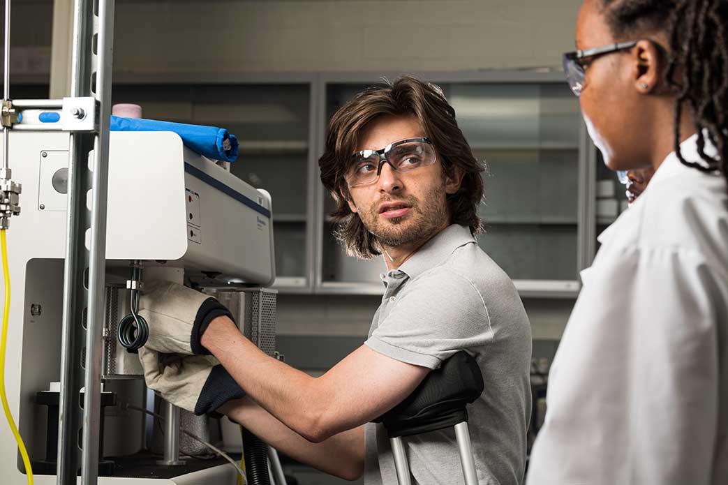 Two researchers looking an an optical instrument array