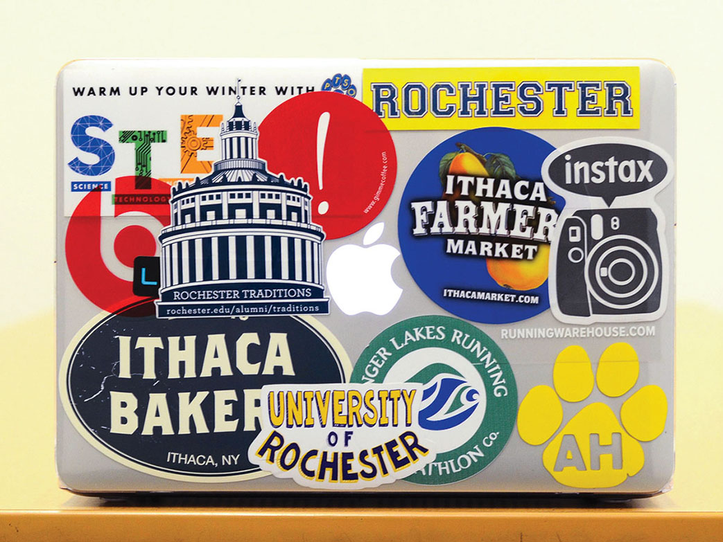 laptop covered in stickers with Rochester themes.
