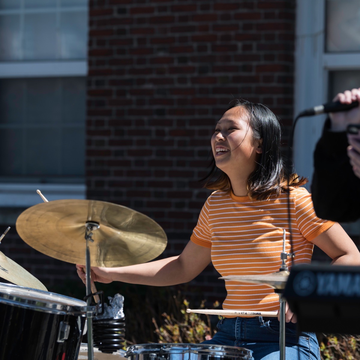University of Rochester student plays the drums outside