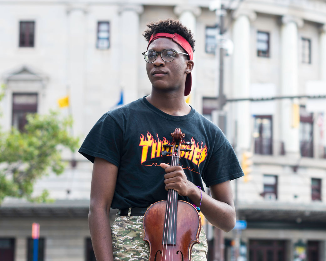 Student plays instrument on stage