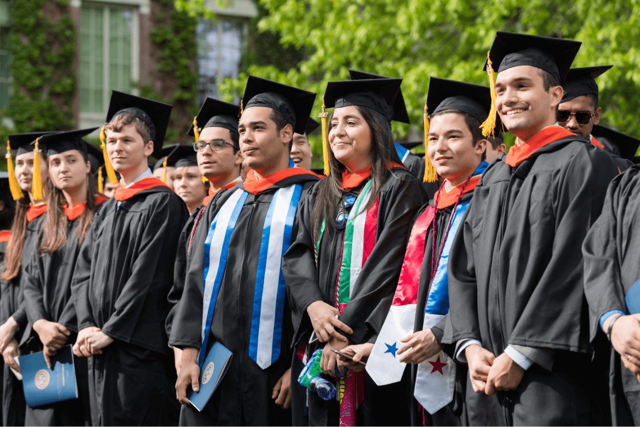 Students in cap and gowns at University of Rochester graduation ceremony