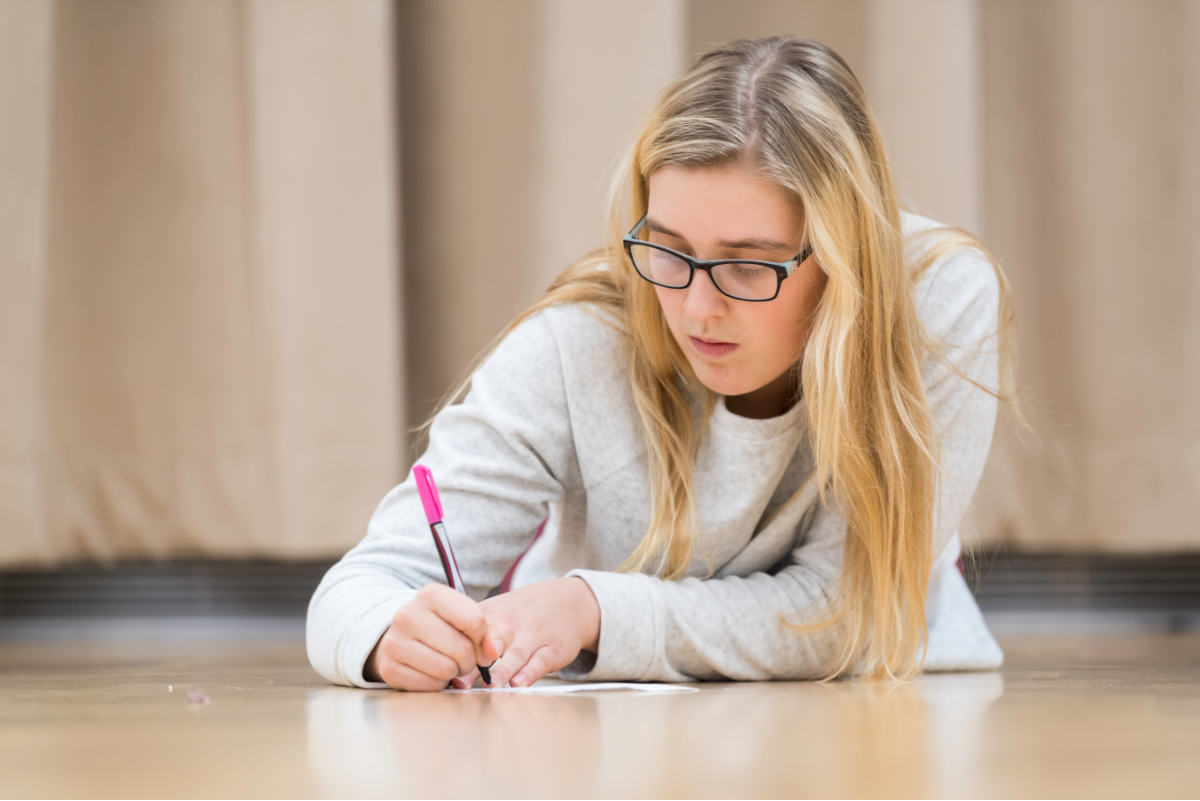 Student taking notes at University of Rochester